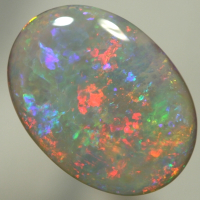SOLID SEMI BLACK OPAL Large opal, red to blue to greens with a hint of gold. SEE VIDEO
